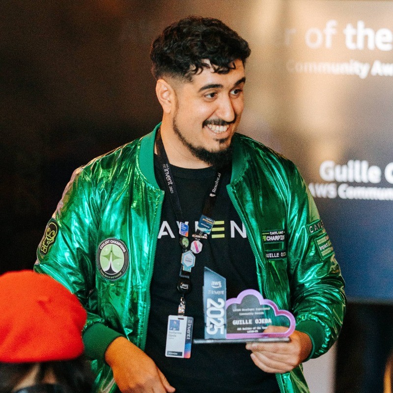 Guille Ojeda in green AWS clothing holding an award